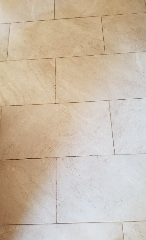 Tile floor with dirty grout before cleaning